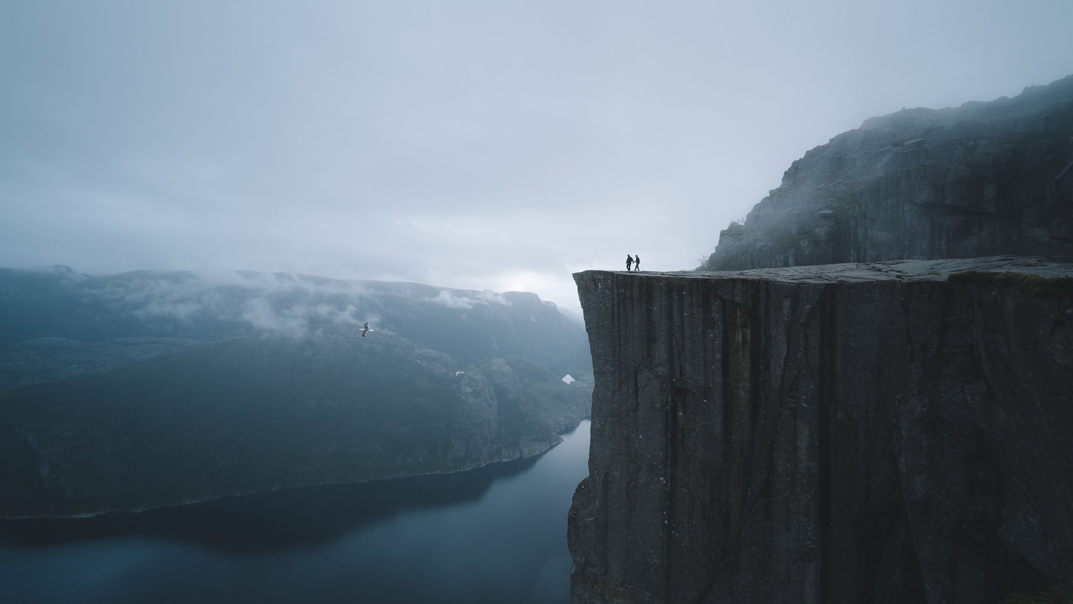 Two People On Mountain Cliff